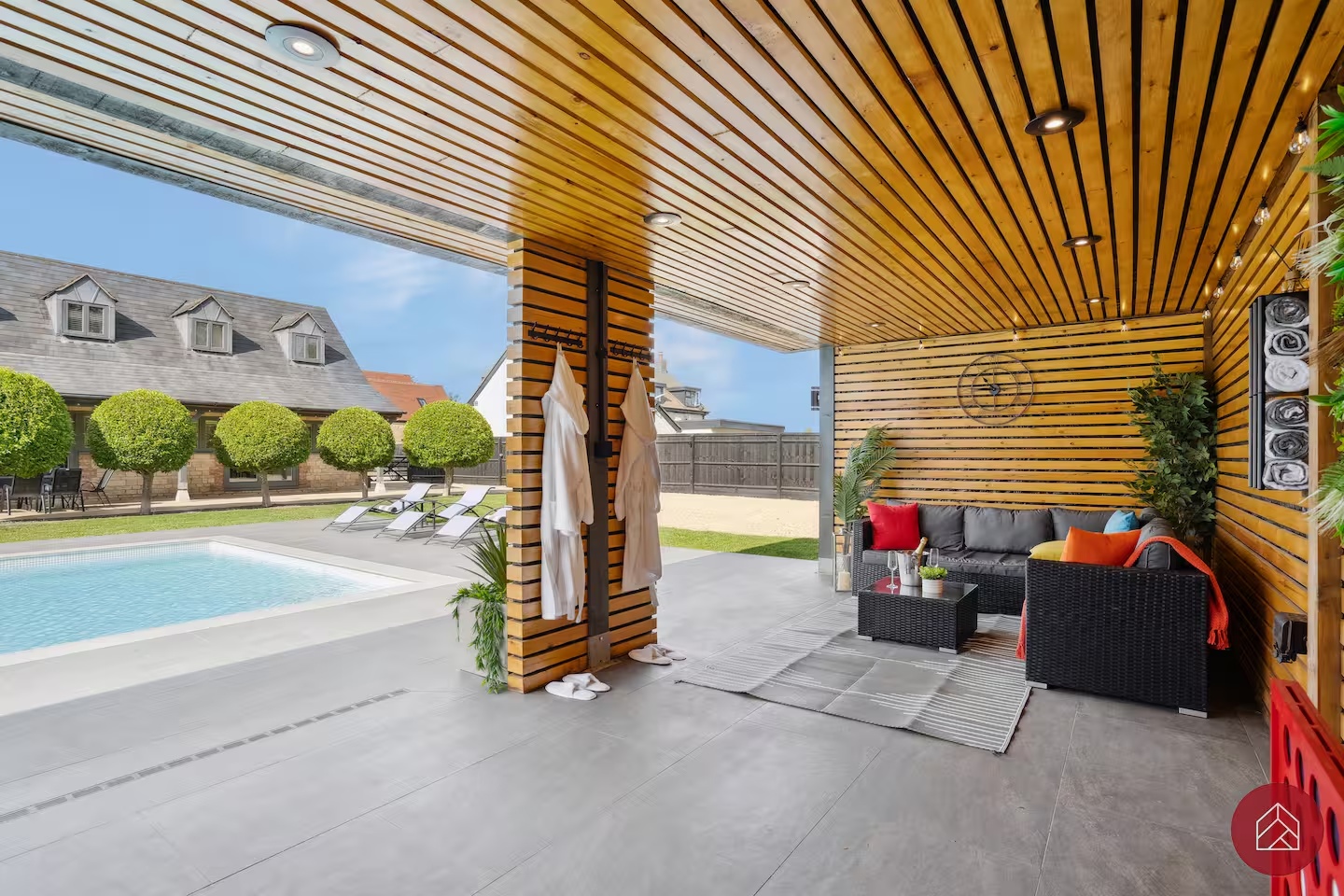Covered poolside lounge seating within the private garden bar