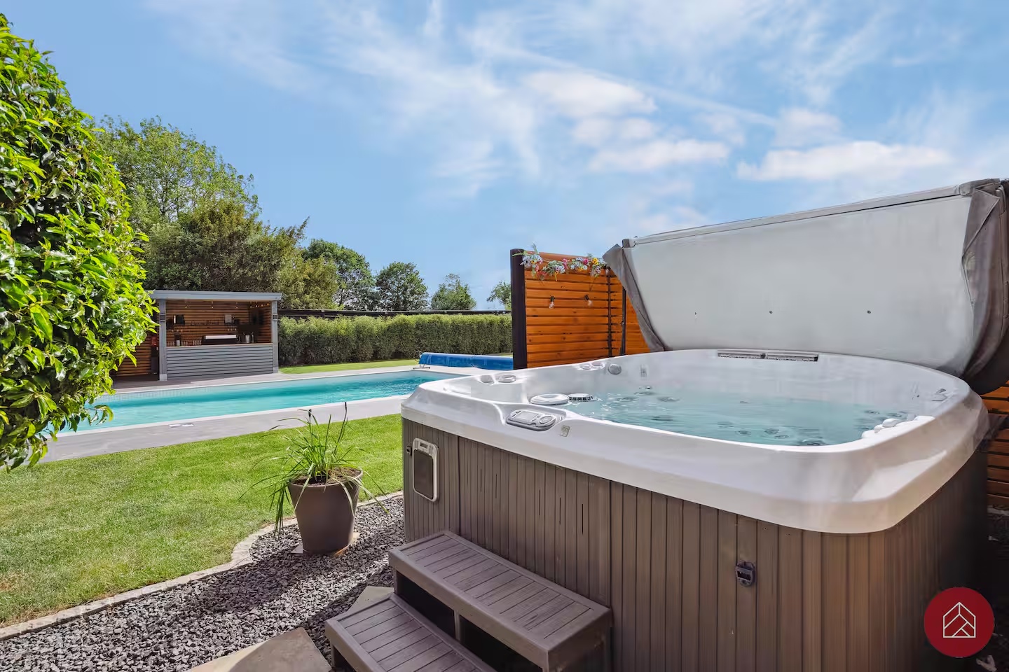 Private hot tub overlooking the swimming pool and garden
