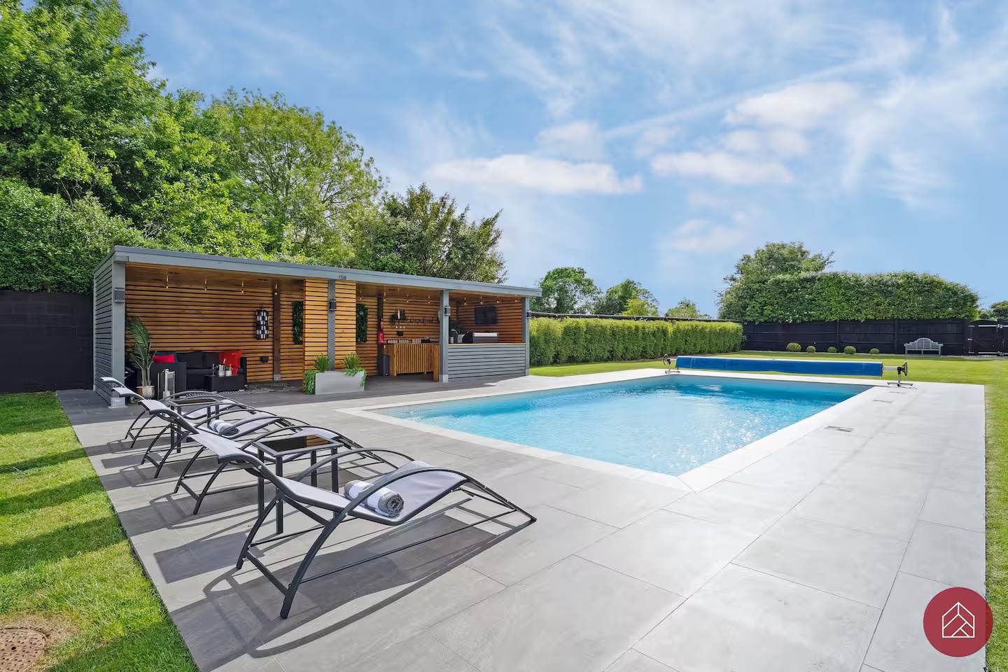 Heated swimming pool and garden bar on a summer day at Ingleby Retreat