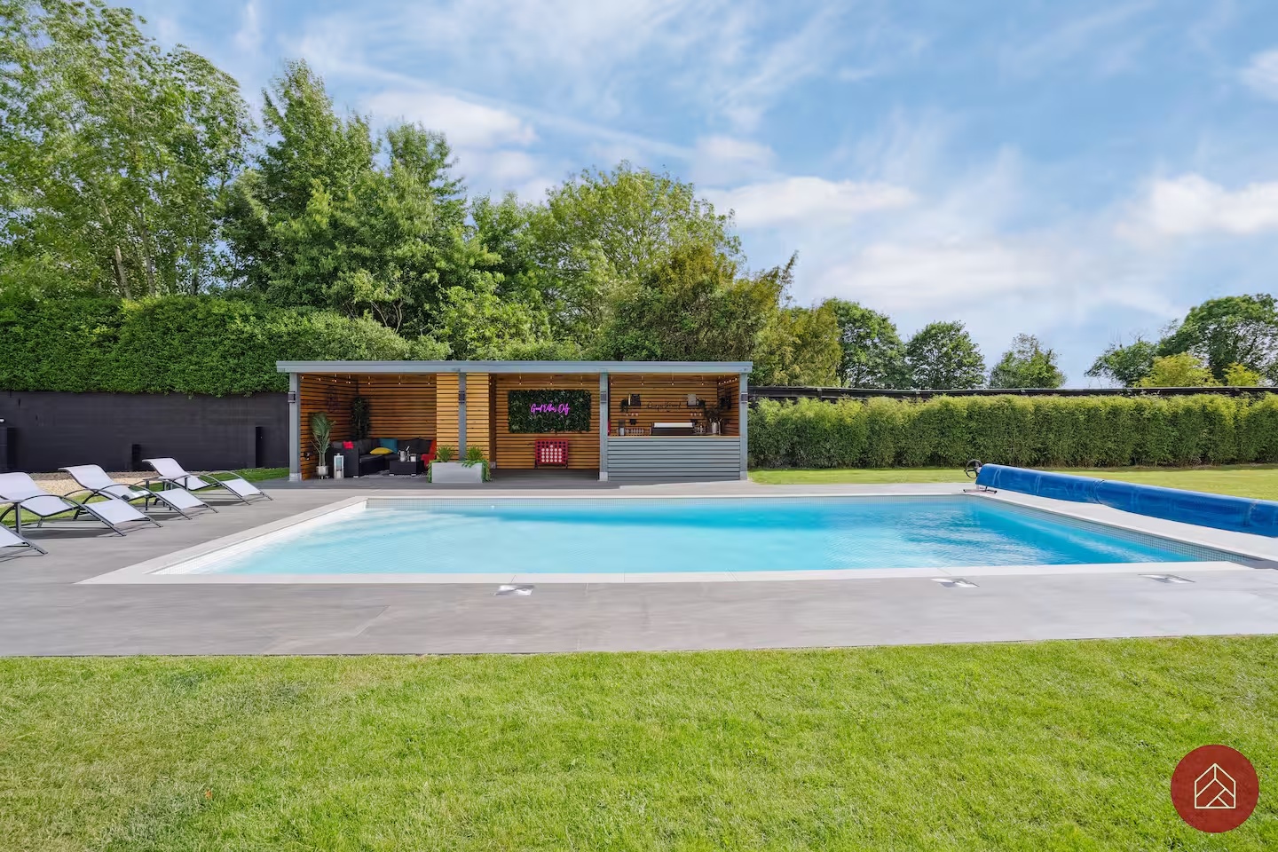 Summer view across the pool towards the outdoor bar
